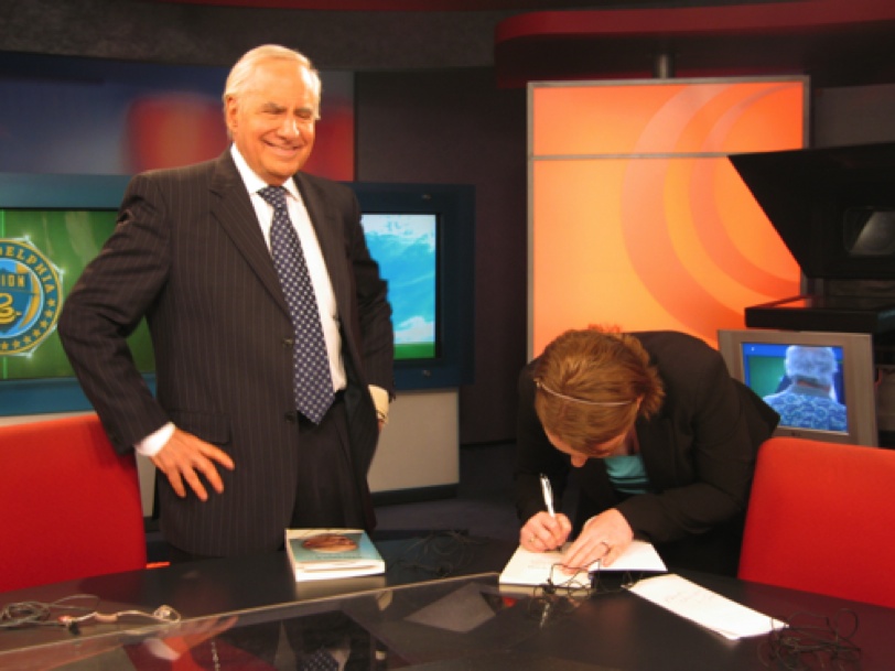 Dr. Van Scoy signing her book for Larry Kane